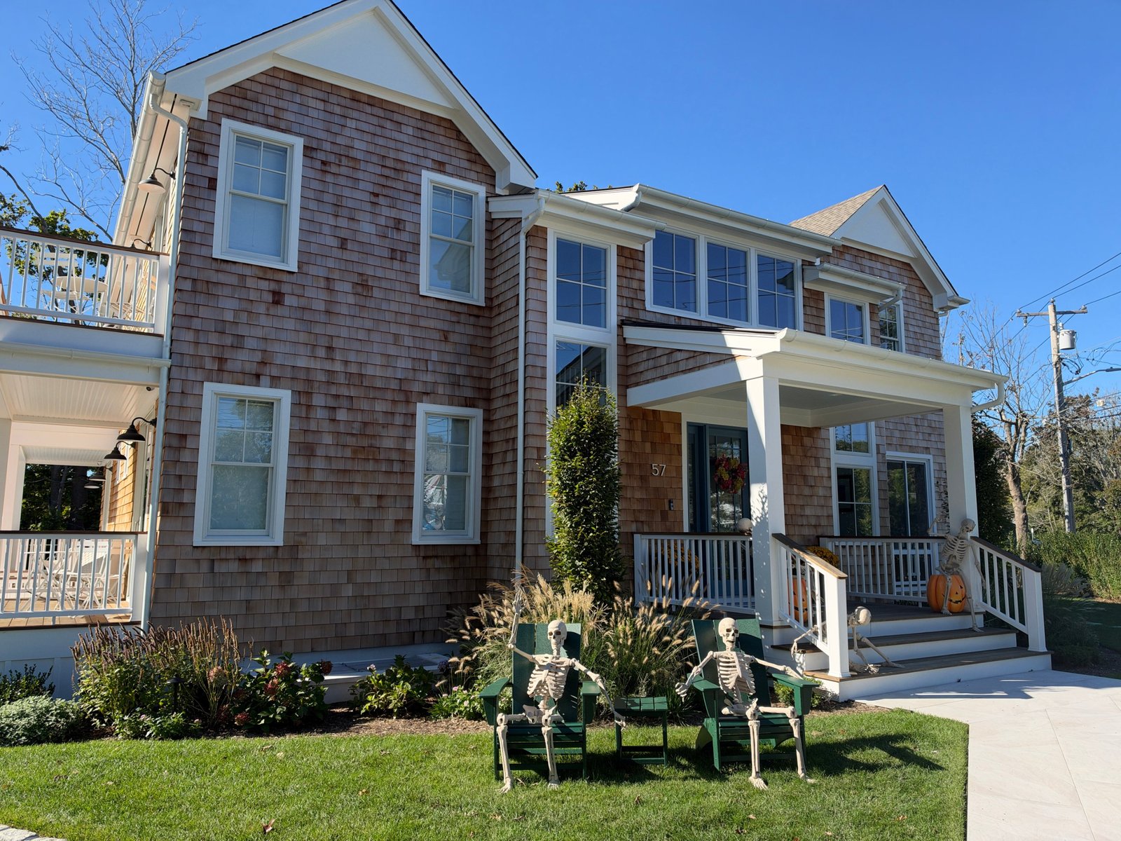 The finished front of the bed and breakfast with planted gardens and a welcoming porch.