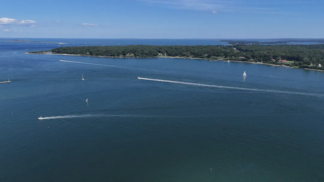 Aerial view of Greenport Harbor with sailboats, looking toward Shelter Island