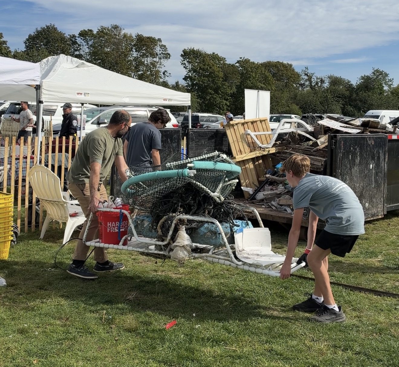 Volunteers hauling a load of collected debris to the dumpsters at the festival