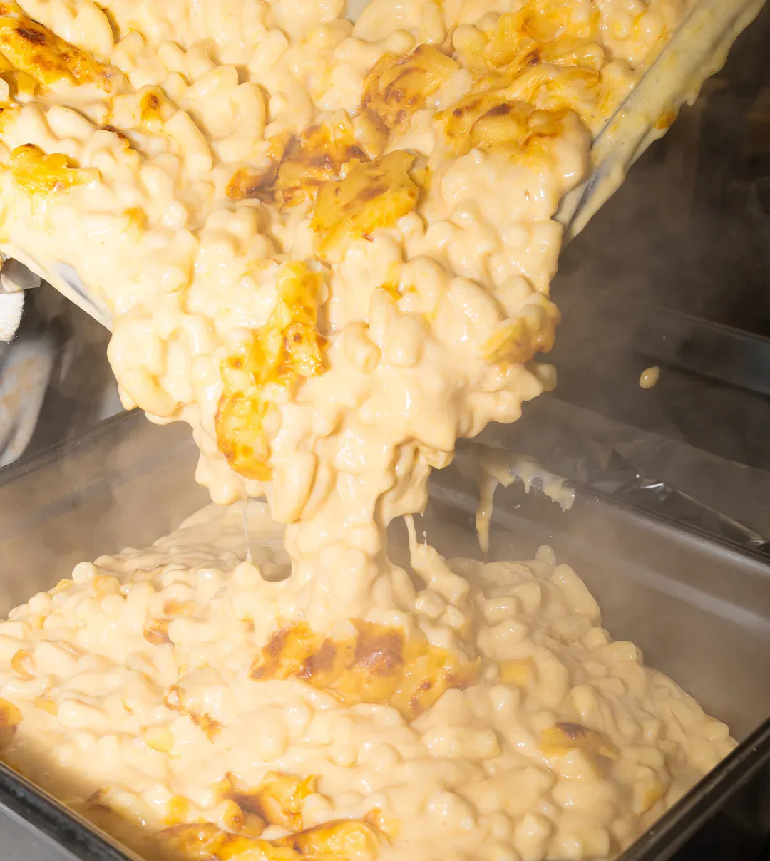 Fresh mac and cheese poured into a steam-table tray in the kitchen at Schmidt’s Country Market in Quogue, Long Island