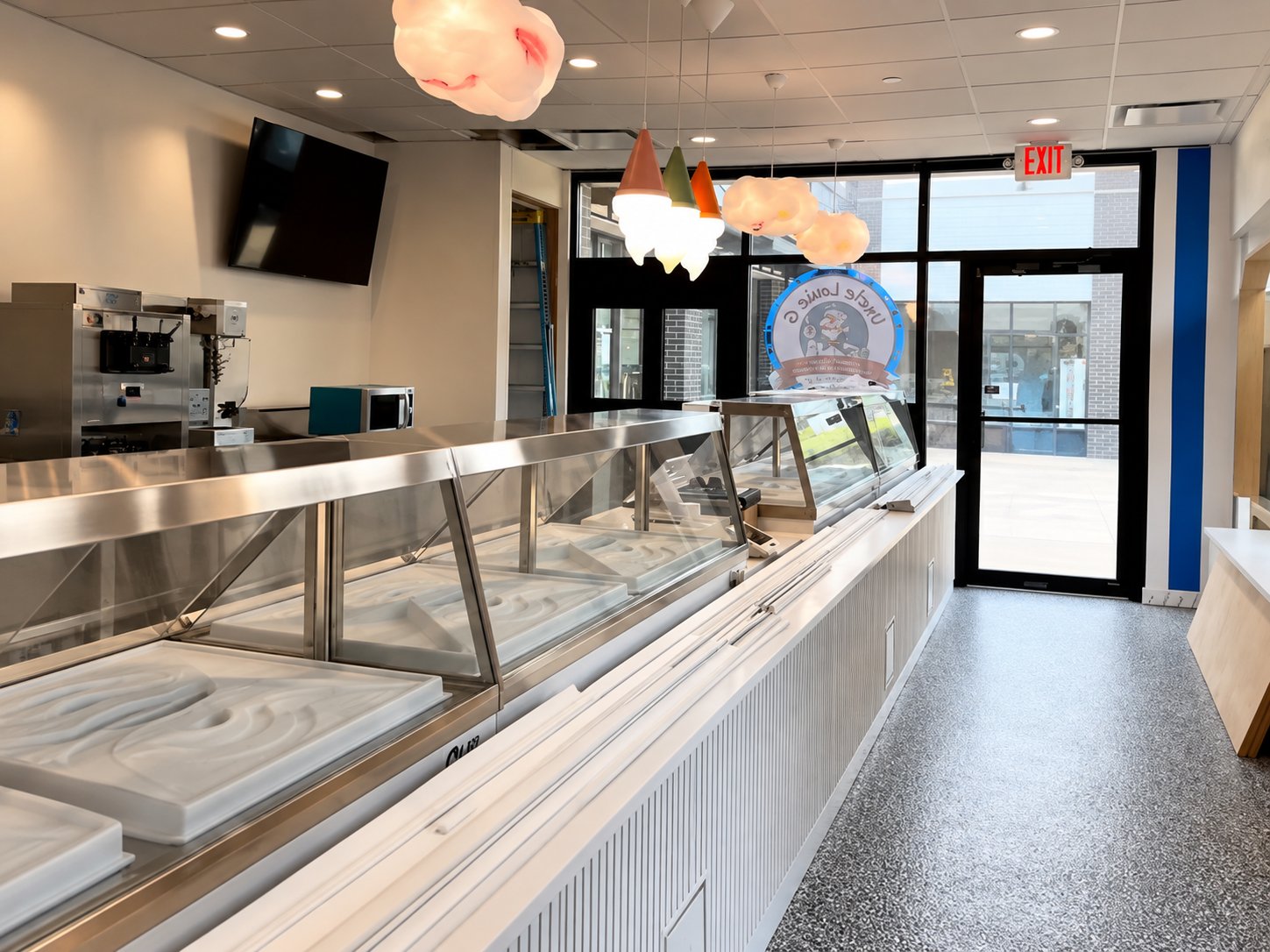 Inside the Uncle Louie G shop, with Italian ice cases and cone shaped pendant lights.