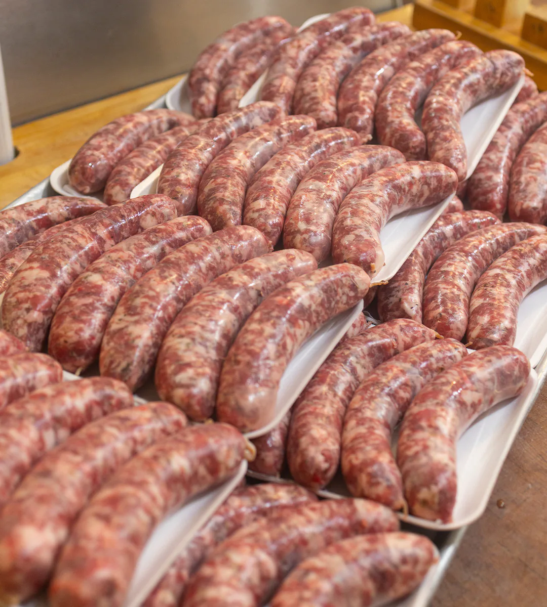 Trays of house-made Italian sausage in the butcher case at Village Prime Meat Shoppe, East Quogue