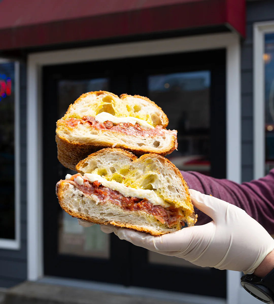 A Village Caprese sandwich held up outside Village Prime Meat Shoppe on Montauk Highway in East Quogue, Long Island